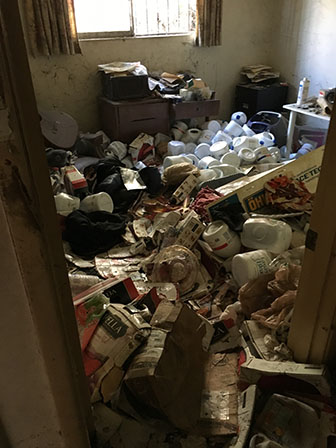 Filthy hoarded bedroom before